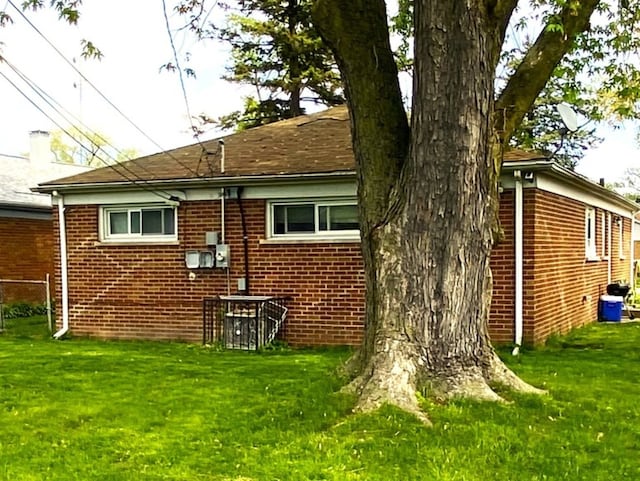 rear view of property with a lawn