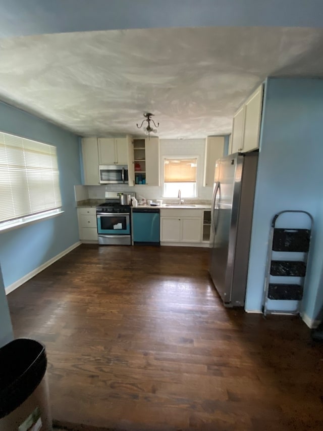 kitchen featuring sink, stainless steel appliances, dark hardwood / wood-style flooring, and white cabinetry