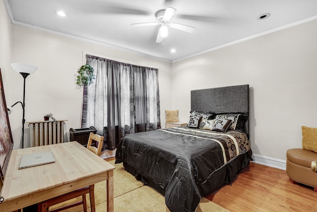 bedroom featuring ornamental molding, ceiling fan, light hardwood / wood-style floors, and radiator heating unit