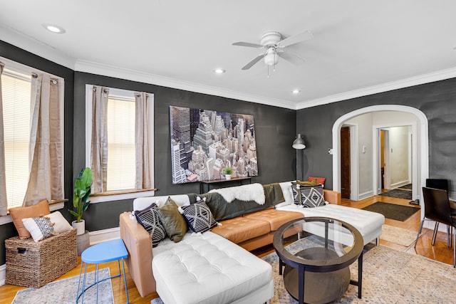 living room with plenty of natural light, hardwood / wood-style floors, ceiling fan, and ornamental molding