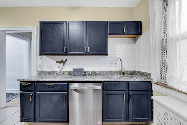 kitchen with stainless steel dishwasher, sink, backsplash, and light tile floors