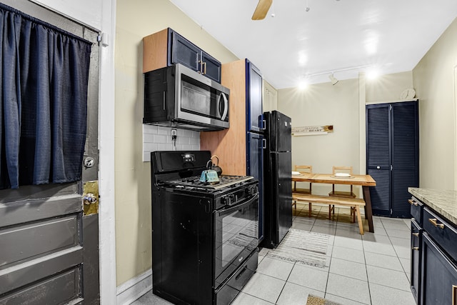 kitchen with black appliances, backsplash, rail lighting, light tile floors, and ceiling fan