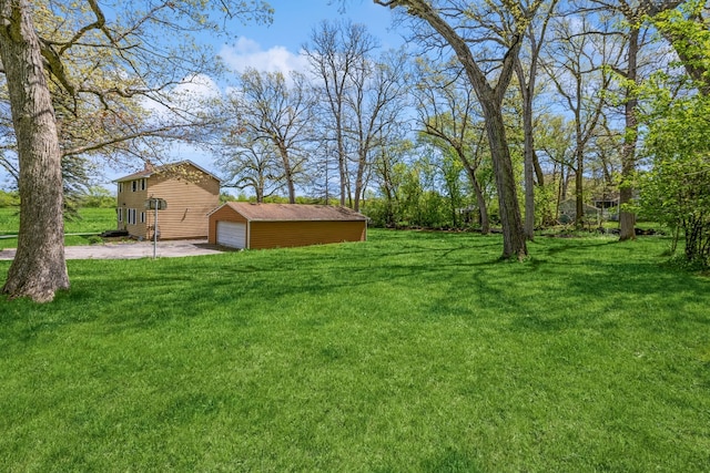 view of yard featuring an outdoor structure and a garage