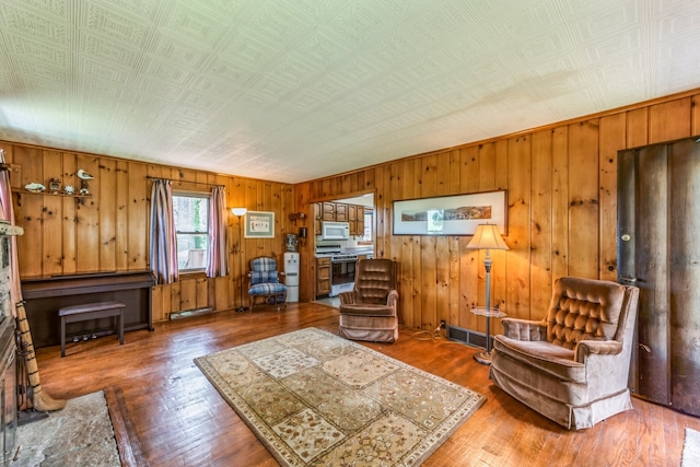 living room featuring wood-type flooring and wood walls