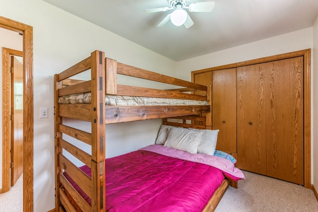 carpeted bedroom with a closet and ceiling fan