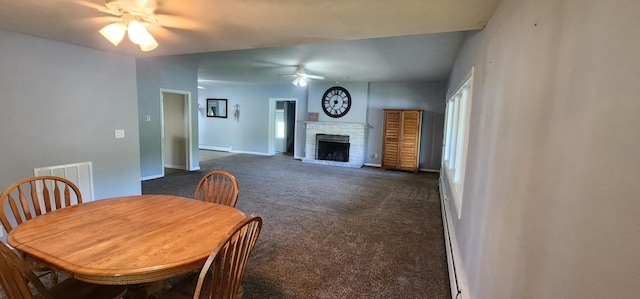 carpeted dining space featuring baseboard heating, ceiling fan, and a brick fireplace