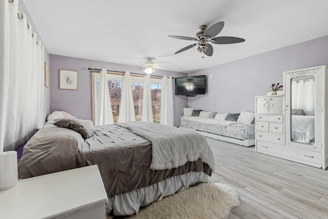 bedroom with ceiling fan and light hardwood / wood-style flooring