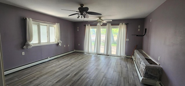 interior space featuring a baseboard heating unit and ceiling fan