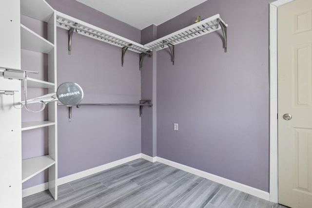 spacious closet featuring hardwood / wood-style floors