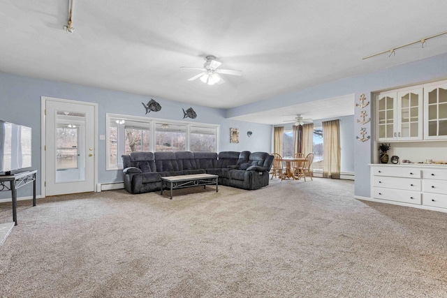 living room featuring track lighting, a baseboard radiator, and carpet floors