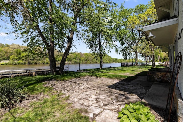 view of yard with a patio and a water view