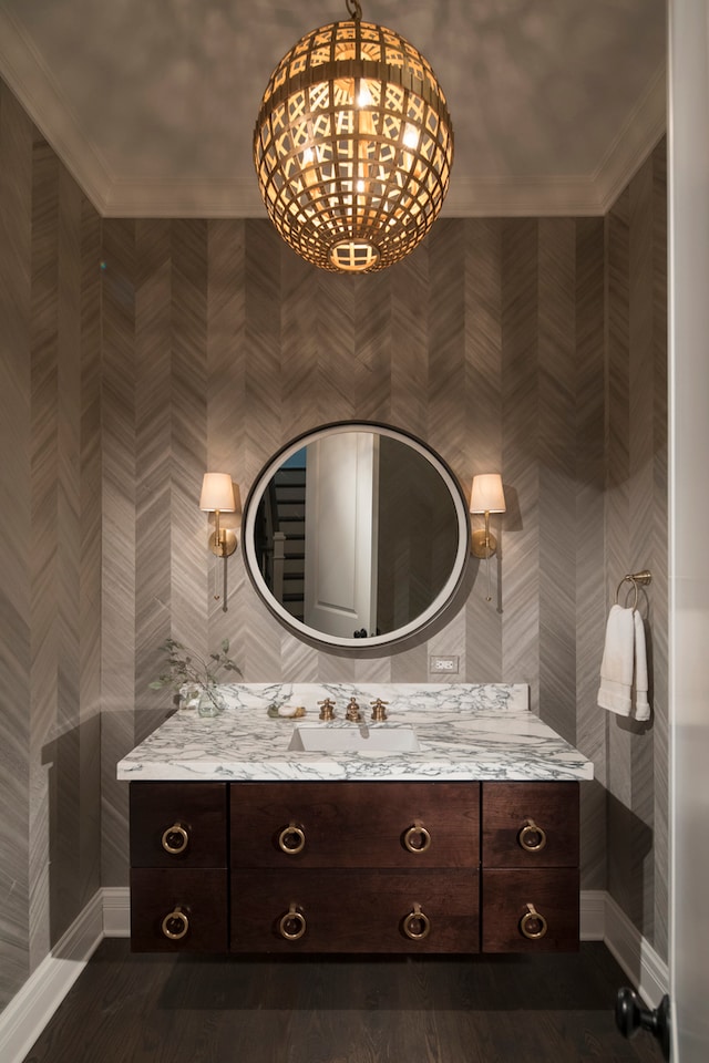 bathroom featuring tile walls, tasteful backsplash, vanity, and crown molding