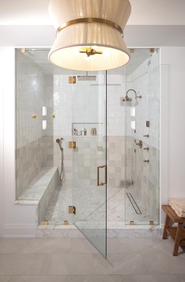 bathroom featuring tile flooring and a shower with door