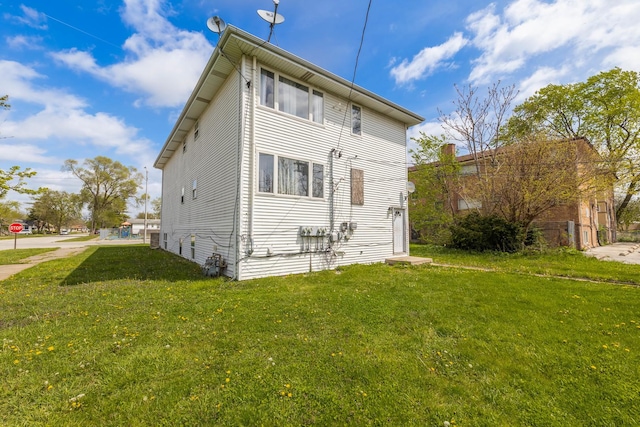 back of house with a lawn