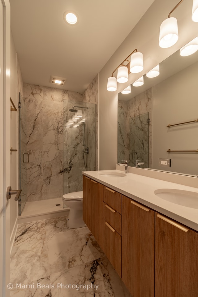 bathroom with walk in shower, toilet, double vanity, and tile floors