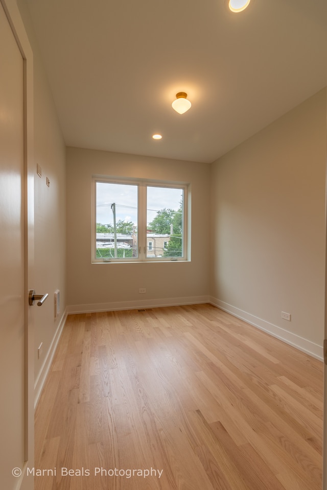 spare room with light wood-type flooring