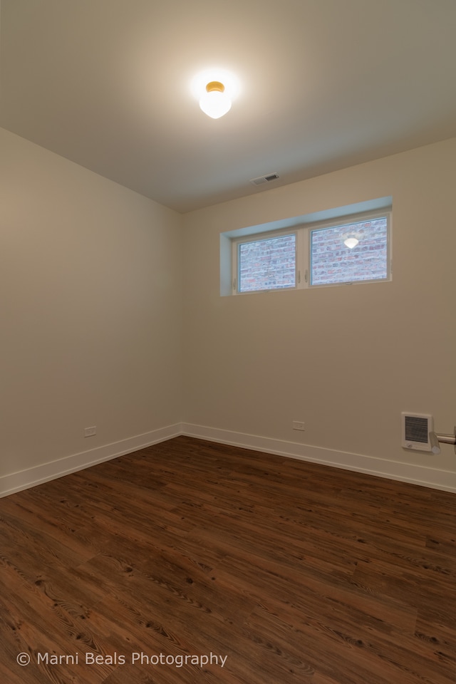 unfurnished room featuring dark wood-type flooring