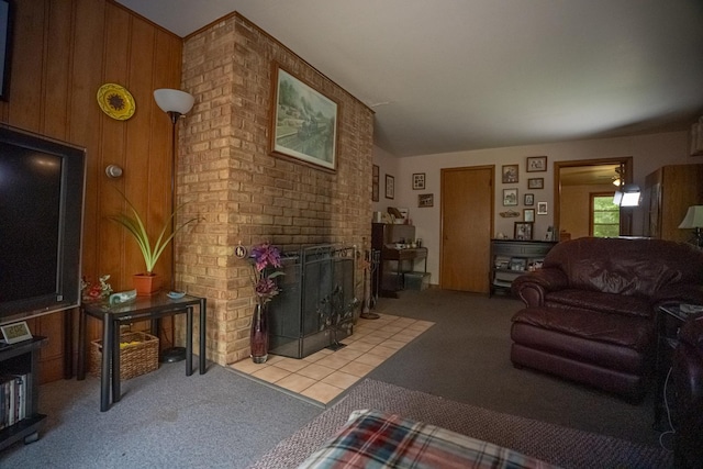 carpeted living area featuring wooden walls and a fireplace