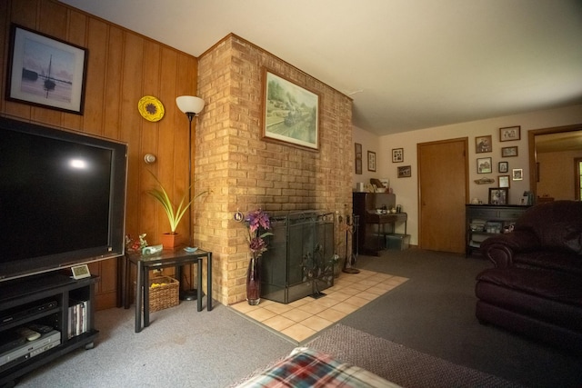 carpeted living area featuring a brick fireplace and wood walls