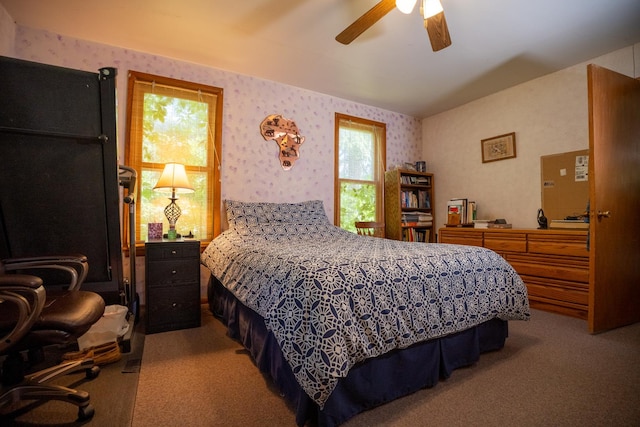 bedroom featuring a ceiling fan, light colored carpet, and wallpapered walls