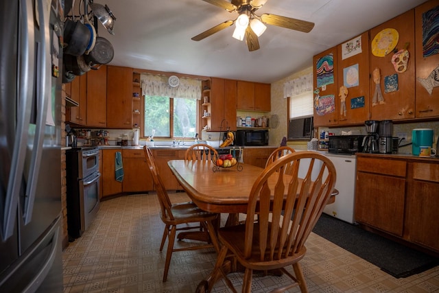 kitchen with light floors, range with two ovens, open shelves, and freestanding refrigerator