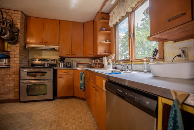 kitchen featuring stainless steel appliances, light countertops, a sink, and under cabinet range hood