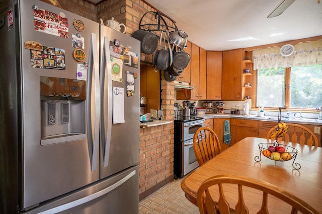 kitchen featuring brown cabinets, stainless steel appliances, light countertops, under cabinet range hood, and open shelves