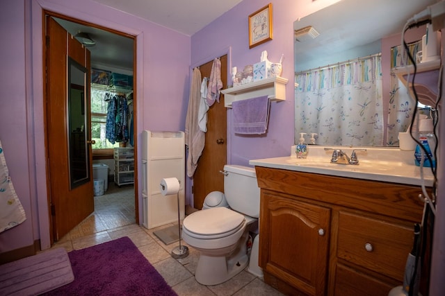 full bathroom featuring tile patterned flooring, vanity, and toilet