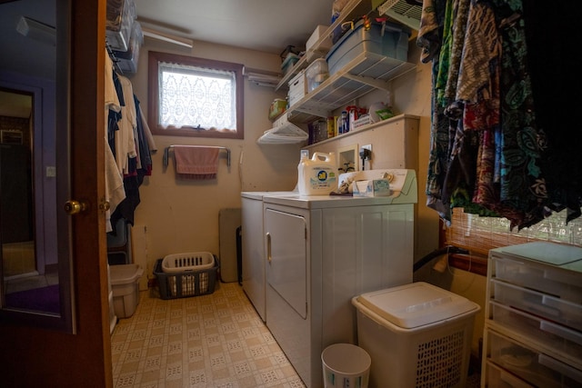 laundry area featuring laundry area, tile patterned floors, and washing machine and clothes dryer