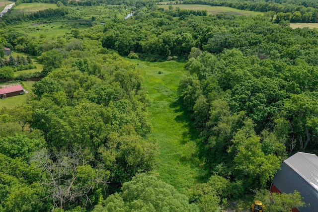 drone / aerial view featuring a wooded view