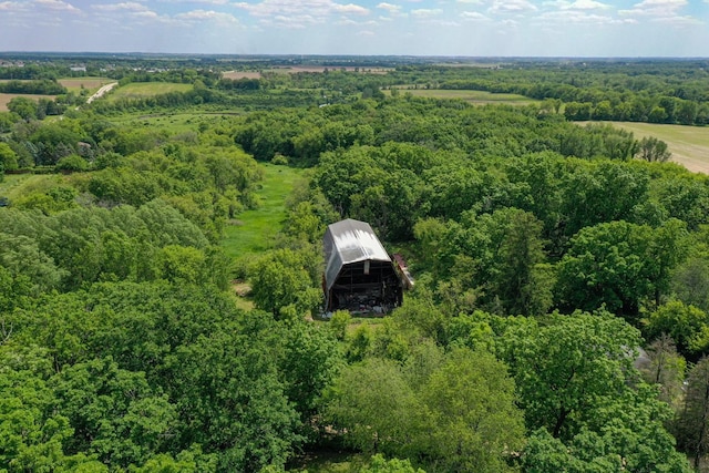 birds eye view of property featuring a view of trees