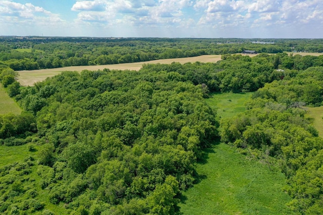 birds eye view of property featuring a view of trees