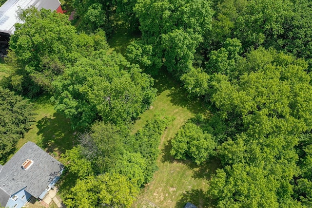 drone / aerial view featuring a view of trees