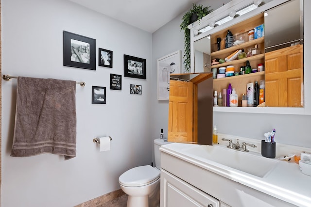 bathroom featuring oversized vanity, toilet, and tile flooring