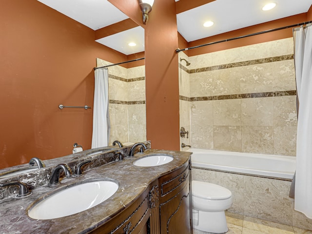 full bathroom with vanity with extensive cabinet space, shower / tub combo, double sink, toilet, and tile floors