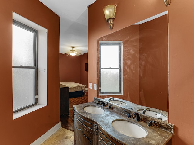 bathroom with tile flooring, dual sinks, ceiling fan, and oversized vanity