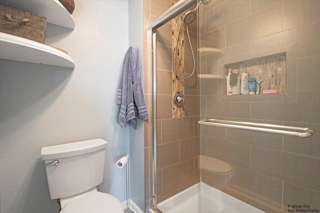 bathroom featuring a shower stall and toilet