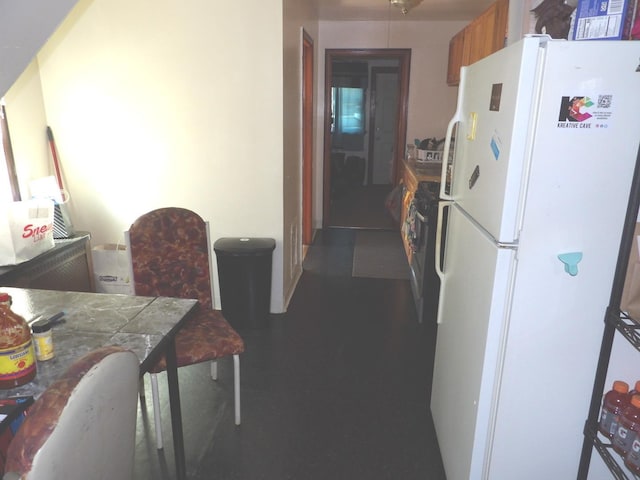 kitchen featuring white fridge and tile counters