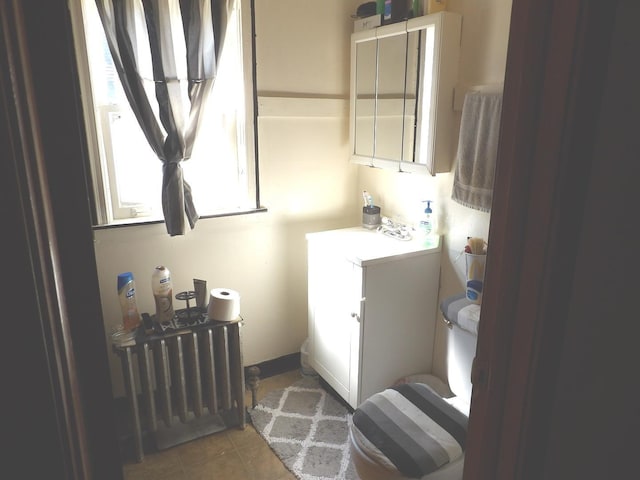 bathroom featuring vanity, toilet, and tile floors