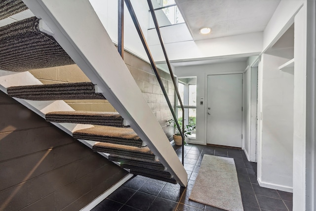 foyer entrance with dark tile floors