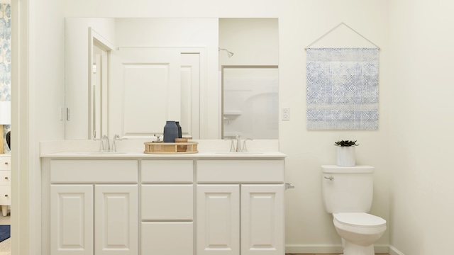 bathroom with double sink, toilet, and oversized vanity