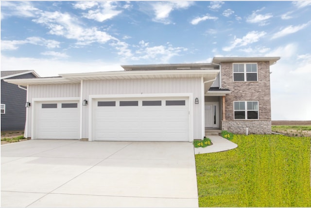 view of front of home with a garage and a front yard