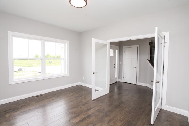 unfurnished room featuring dark hardwood / wood-style flooring and french doors