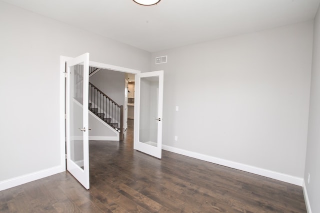 empty room with french doors and dark hardwood / wood-style floors