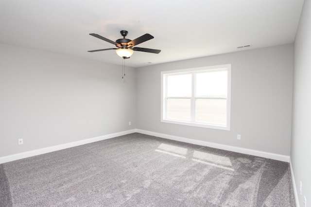 spare room with ceiling fan and carpet floors