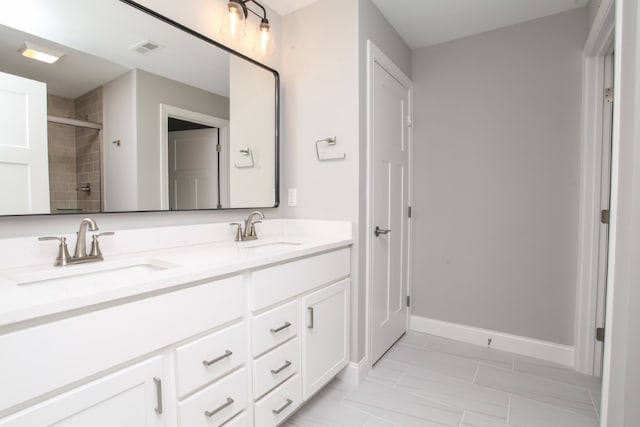 bathroom featuring dual sinks, tile flooring, and large vanity