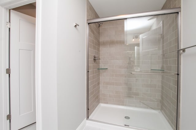 bathroom with a shower with door