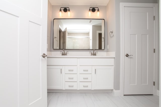 bathroom with oversized vanity, double sink, and tile floors