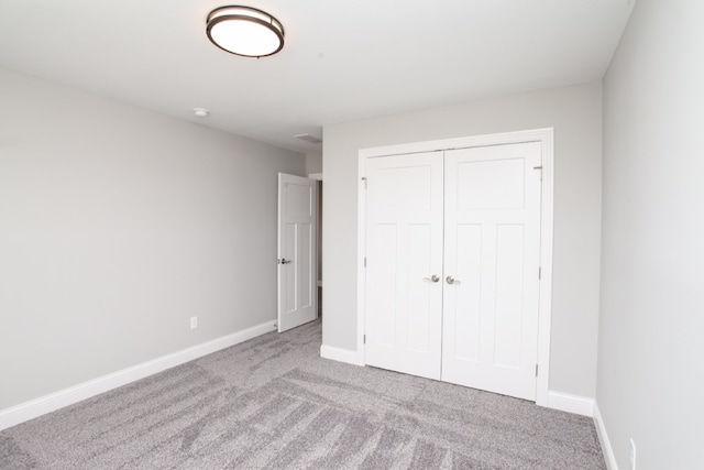 unfurnished bedroom featuring a closet and carpet