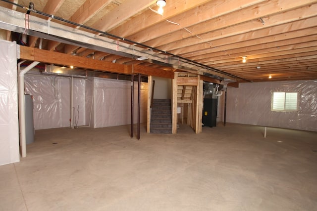 basement featuring heating utilities and water heater